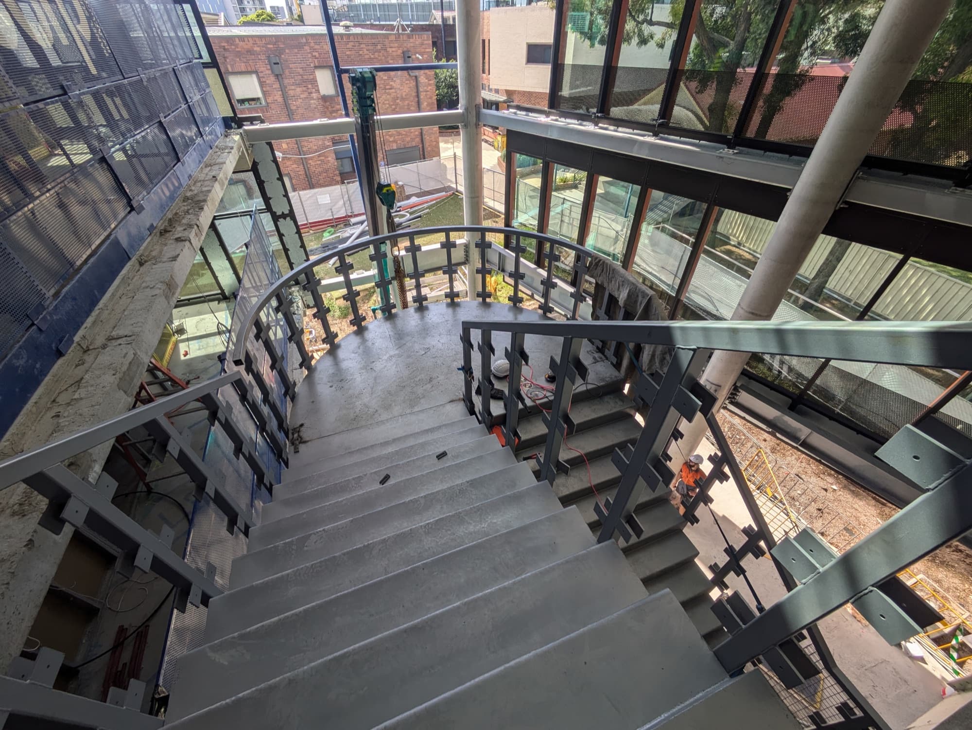 Curved steel stair with flat bar balustrade, looking down, Strathfield